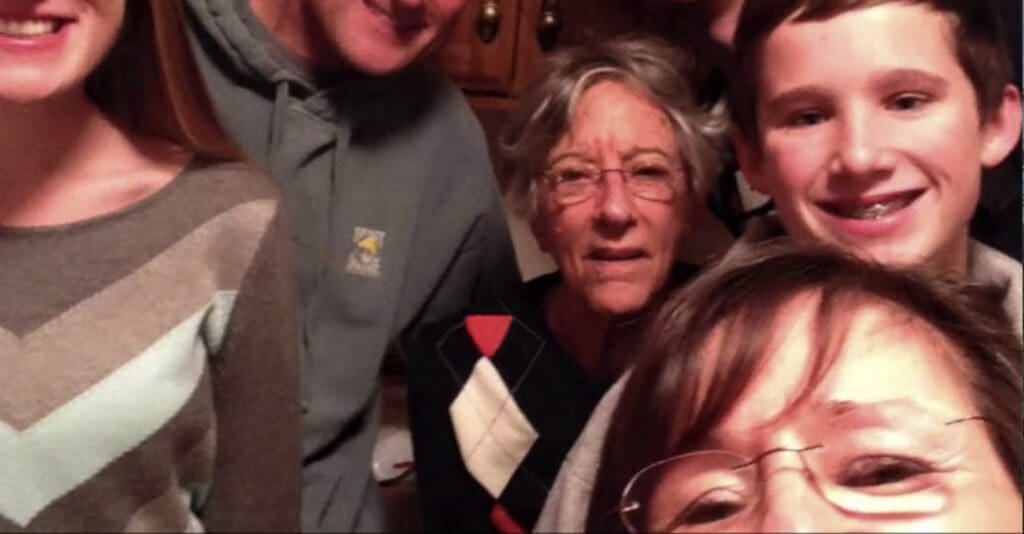 Charter Senior Living of Washington Video Thumbnail Family Group Surrounded by senior living resident